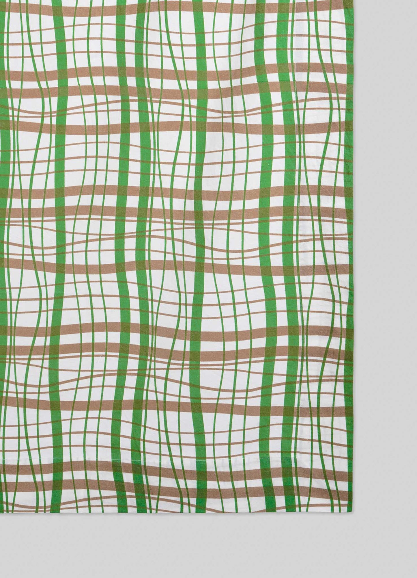 The Viya Madras Check Green & Beige Table Cloth features a wavy plaid of intersecting green and brown lines on white, blending contemporary tradition with classic Indian textiles for a striking optical illusion effect.
