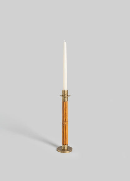 The VIYA Namsai Candle Holder Medium, a tall cylindrical wooden holder with elegant brass accents, holds a white taper candle upright against a plain light gray background.
