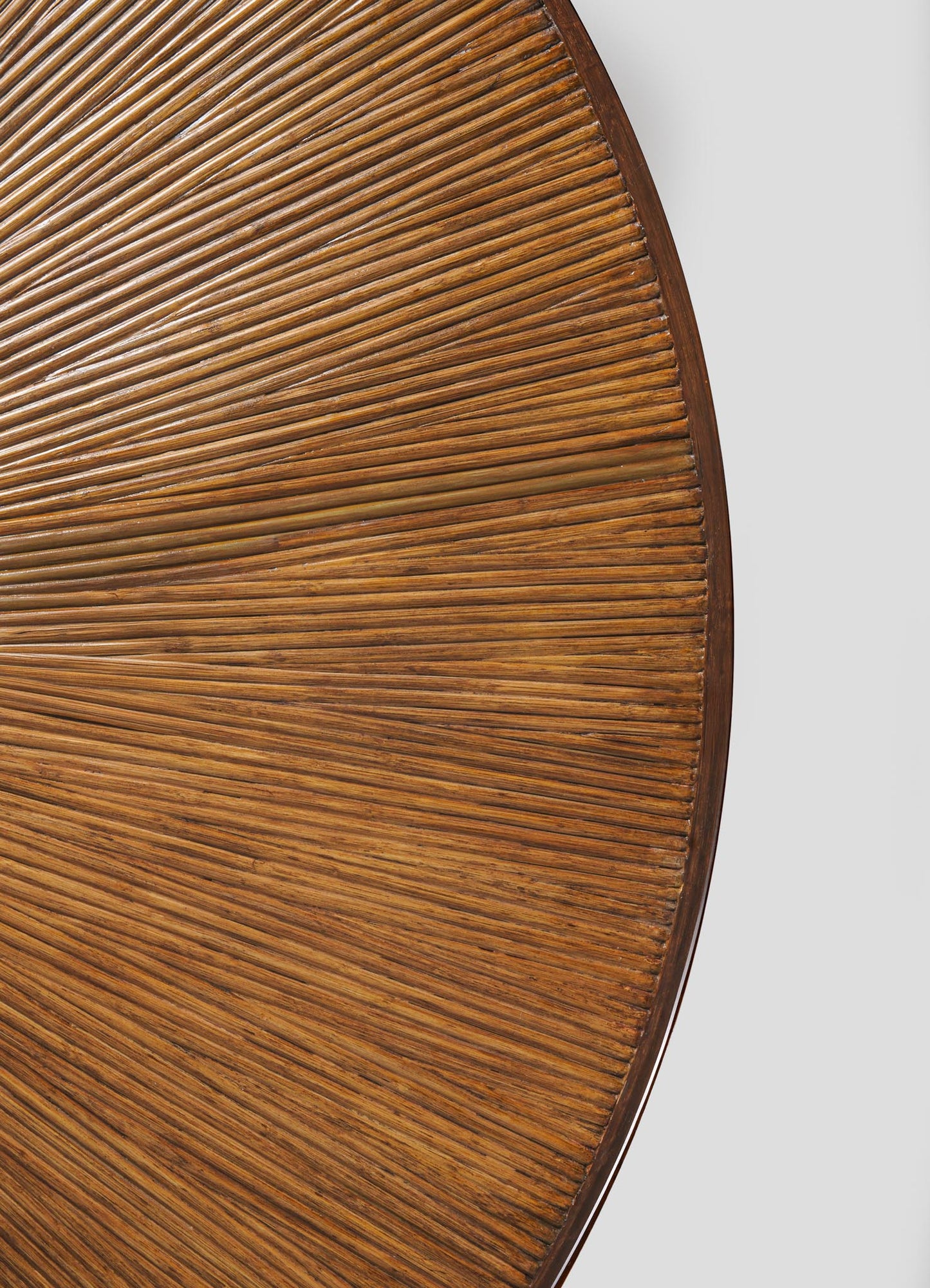 Close-up of the Namsai Dining Table by VIYA, featuring a round wooden tabletop with a textured radiating pattern of narrow grooves and elegant brass trim against a plain white background.