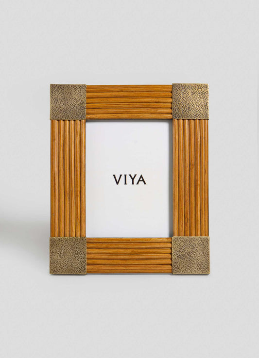 The Namsai Photo Frame Large by VIYA features vertical wooden ridges, textured metal corners, and brass accents, displaying a white insert with "VIYA" in bold black letters at the center.