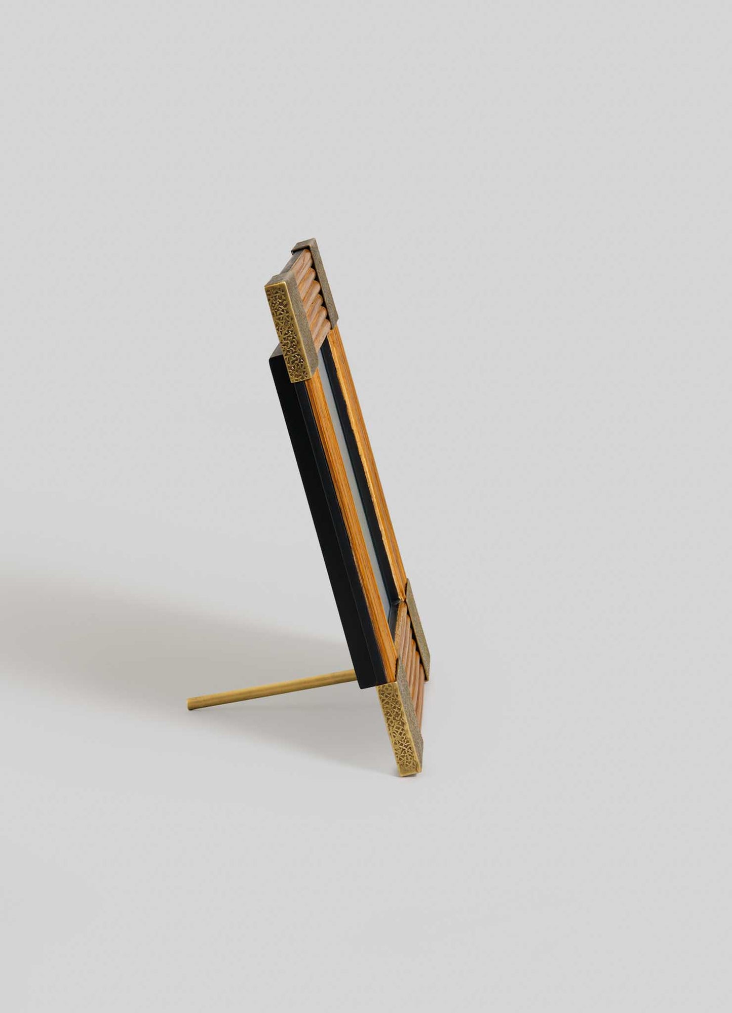 The VIYA Namsai Photo Frame Large, shown from the side with a standing support leg and elegant brass accents, is set against a plain light gray background.