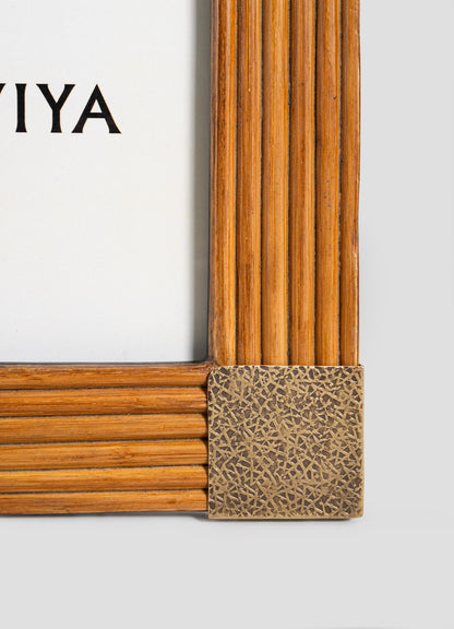 Close-up of the Namsai Photo Frame Small by VIYA, crafted from wood with vertical and horizontal grooves, brass trimmings, and an intricate metal corner; part of the brand name VIYA is visible inside.