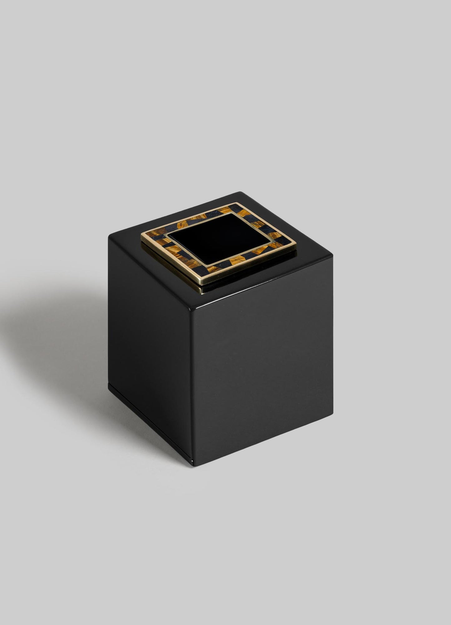 The VIYA Plaza Cube Tissue Box features a sleek black square design with a gold and black Art Deco accent on top, inspired by Bombay's grand cinema halls, shown against a light gray background.