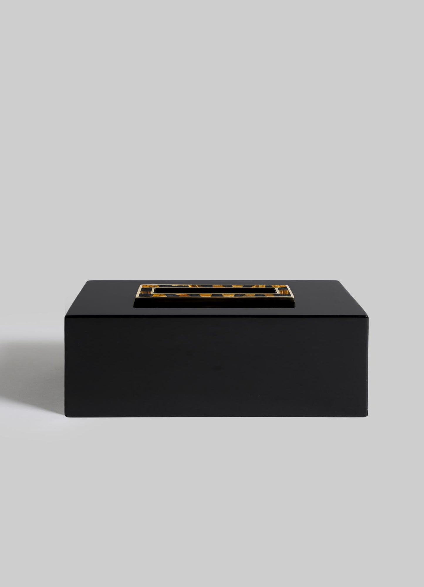 The VIYA Plaza Tissue Box, a sleek rectangular black box with a gold and black Art Deco handle on the lid, set against a plain light gray background, channels the glamour of old Bombay cinema halls.