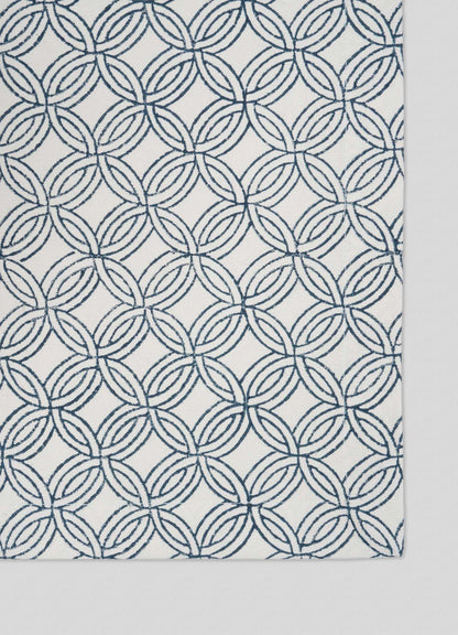 The Viya Paigah Navy Placemats (Set of 4) feature a white background with interlocking navy blue circles, inspired by Hyderabad’s paigah jaalis and Indo-Islamic geometric patterns.