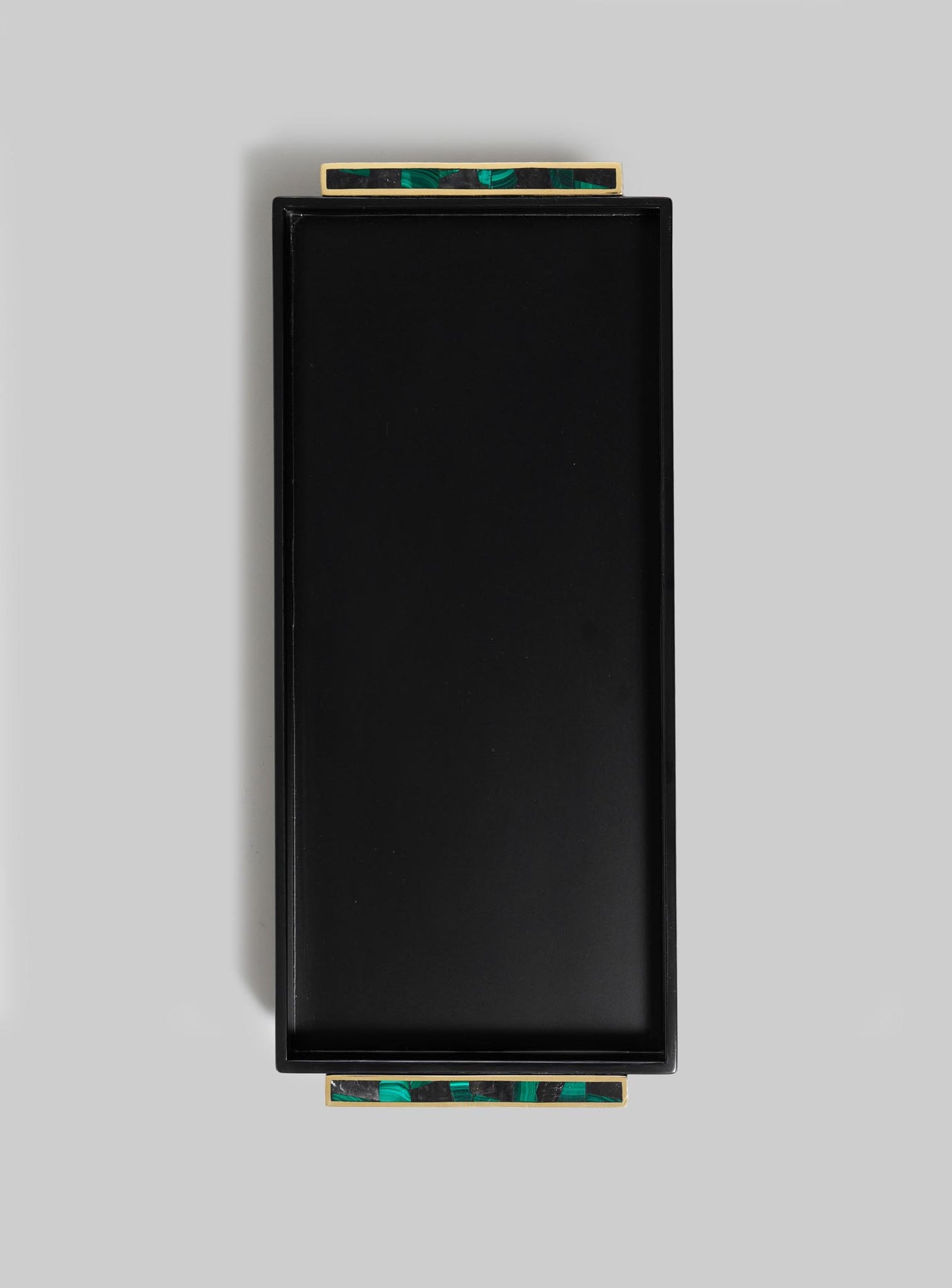 The VIYA Rivoli Black Vanity Tray features a rectangular black design with gold and green marble-patterned handles on opposite sides, evoking Art Deco elegance. Displayed against a plain light gray background.