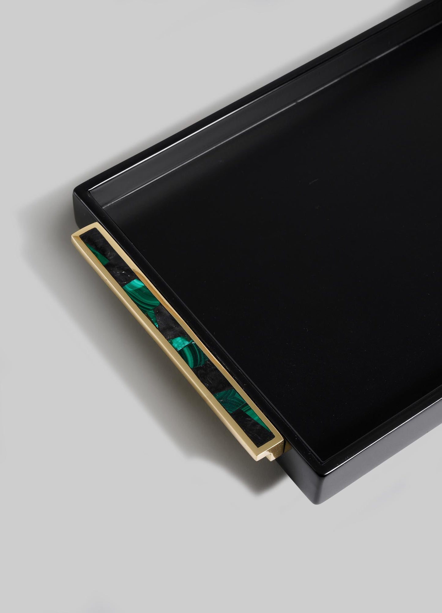 The VIYA Rivoli Black Vanity Tray features a rectangular design with a gold handle and a green and black marbled pattern, inspired by Art Deco-era Bombay, displayed against a light gray background.