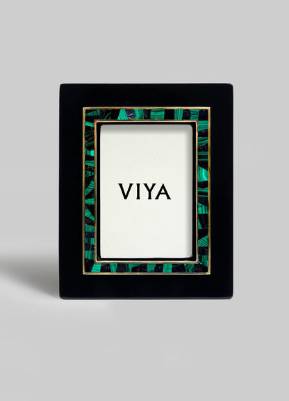 The VIYA Rivoli Photo Frame is a black rectangular frame with green and gold Art Deco accents, shown upright with a VIYA card at the center, evoking the vintage charm of old Bombay cinema halls.