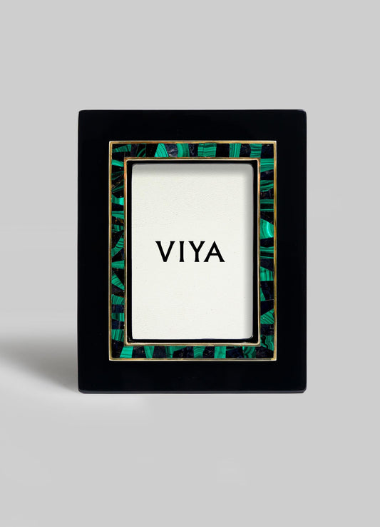 The VIYA Rivoli Photo Frame is a black rectangular frame with green and gold Art Deco accents, shown upright with a VIYA card at the center, evoking the vintage charm of old Bombay cinema halls.