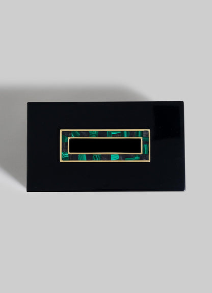The VIYA Rivoli Tissue Box is a rectangular black lacquered piece with a glossy finish and an Art Deco-inspired green and gold inlay on the lid, evoking Bombay cinema halls, shown on a plain light gray background.
