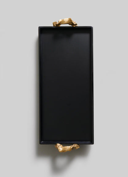 The VIYA Saffron Black Vanity Tray features two gold animal handles, blending ancient Indian-inspired elegance with modern style, displayed on a light gray background.