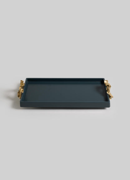 The VIYA Saffron Dark Blue Vanity Tray is a rectangular serving tray with raised edges and gold handles inspired by ancient Indian medicine, shown on a plain light gray background.