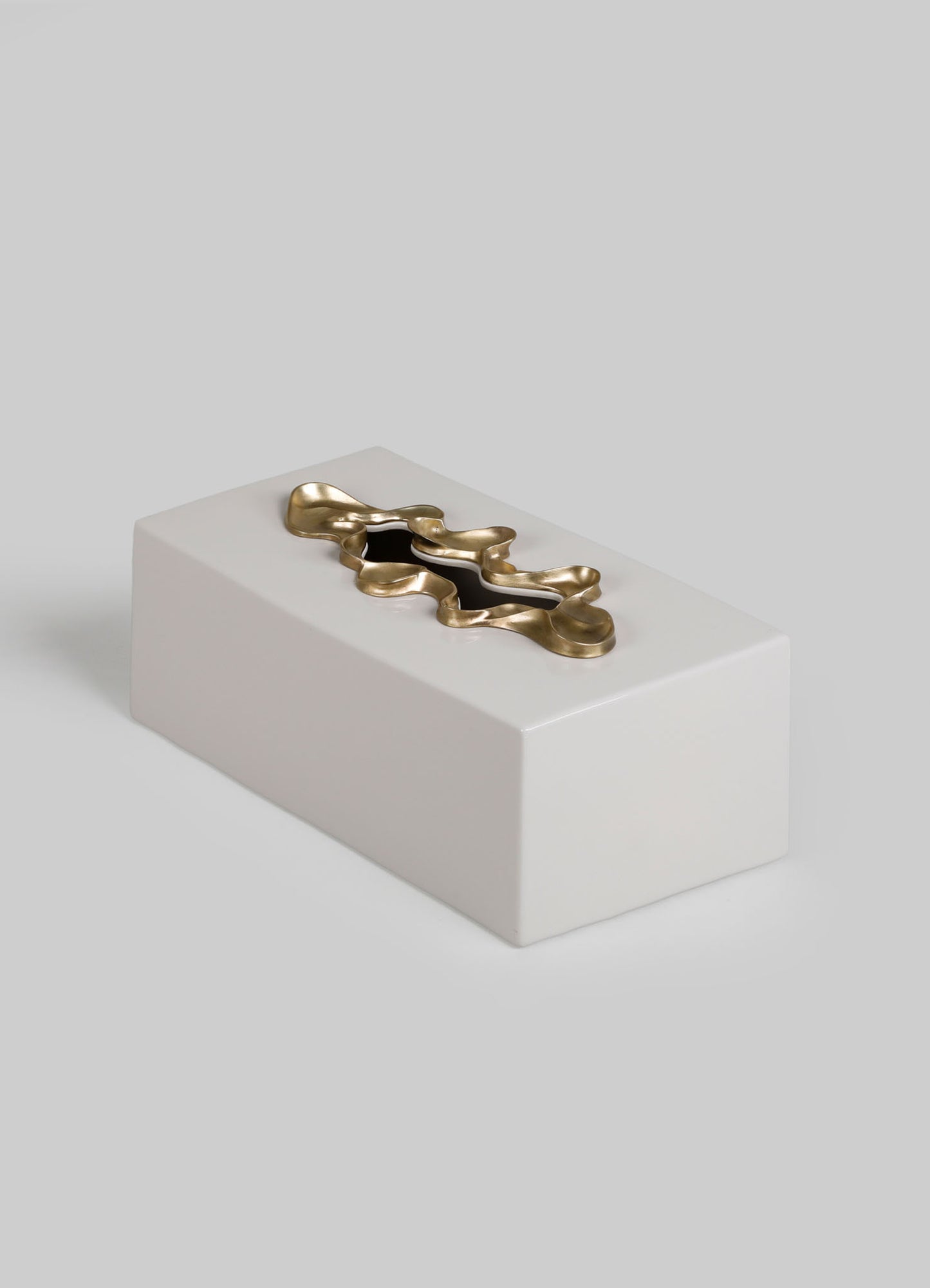 The VIYA Saffron Tissue Box Large is a rectangular white box with a smooth surface, adorned with a wavy metallic gold accent on top inspired by saffron threads, shown against a plain light gray background.