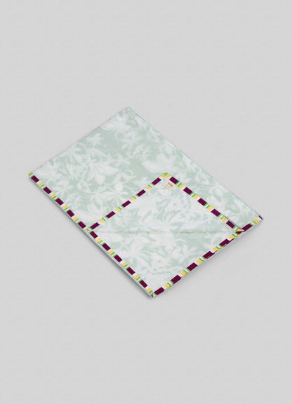 The Viya Spring Bouquet Green King Size Dohar features a light green and white floral pattern inspired by Indian garden bedding, with a yellow, white, and dark red geometric border, shown on a plain light gray background.