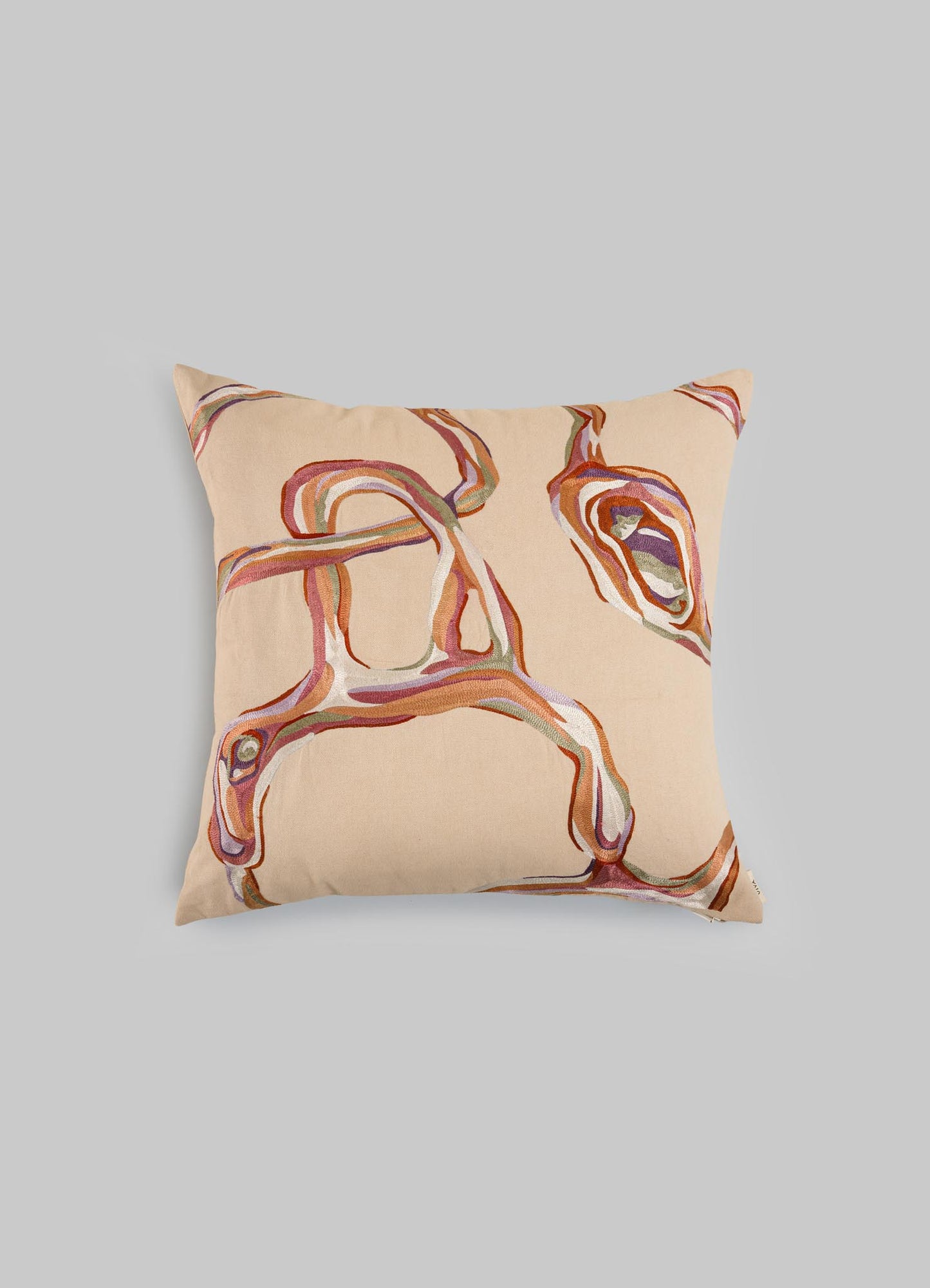 The Viya Tutti Frutti Salmon Pink Cushion Cover 18"x18" features a beige hand-embroidered abstract design in brown, pink, and purple, inspired by Cartier Tutti Frutti, shown against a plain light gray background.