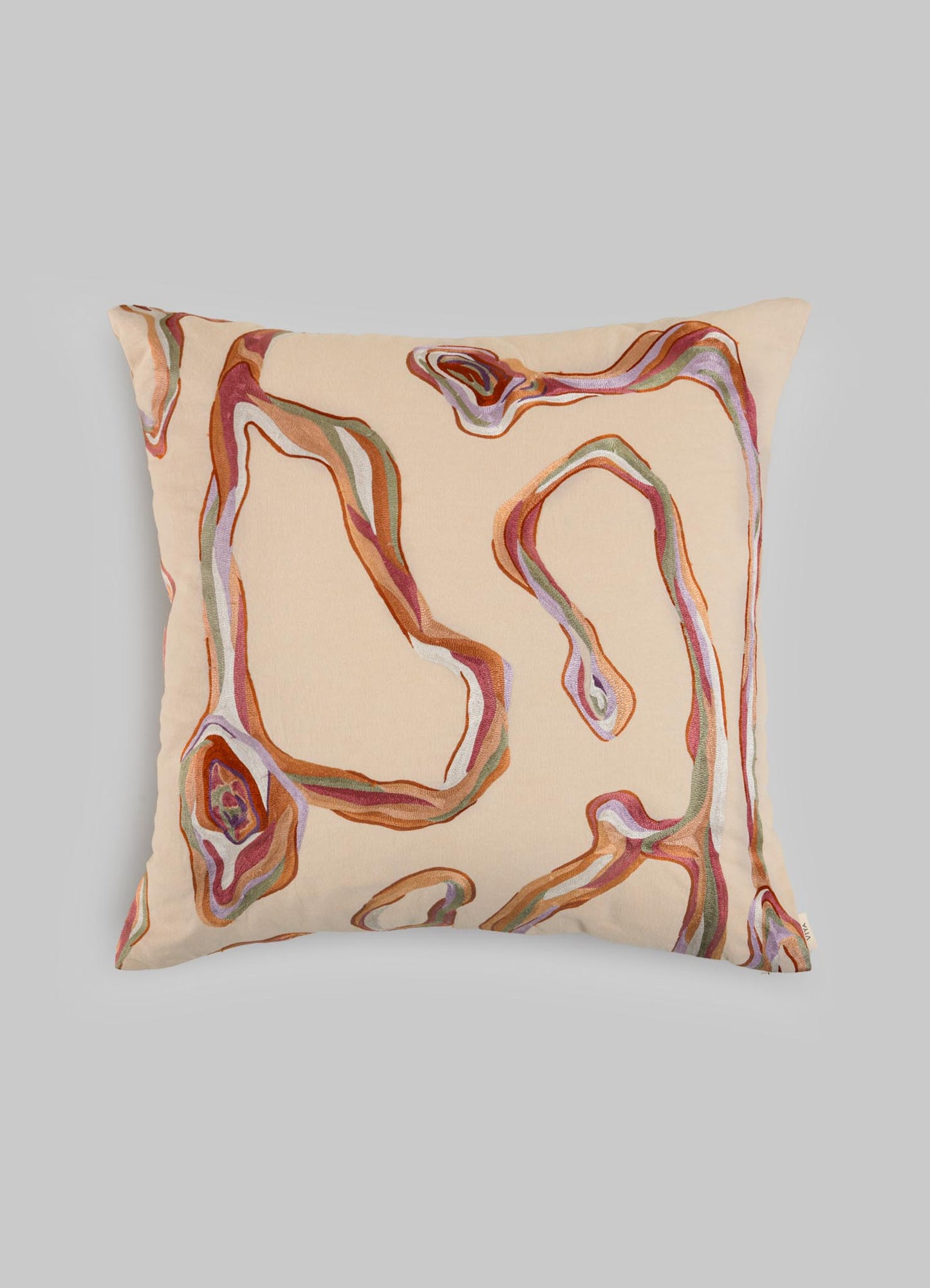 The Viya Tutti Frutti Salmon Pink Cushion Cover (24"x24") features hand-embroidered-inspired abstract wavy lines in brown, red, and green on beige fabric, shown against a plain light gray background.